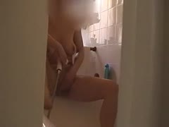 Wife masturbating in the bathtub while alone at home